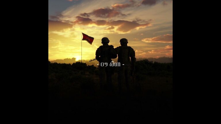 Two Cambodian soldiers standing together at sunset with a national flag waving in the background, symbolizing remembrance and unity on August 1st – inspired by VannDa’s song ‘១ សីហា (August 1st)