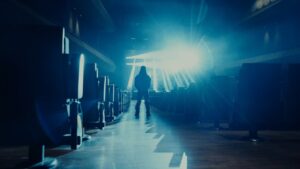 VannDa standing in a blue cinematic theater setting for Neon Light music video